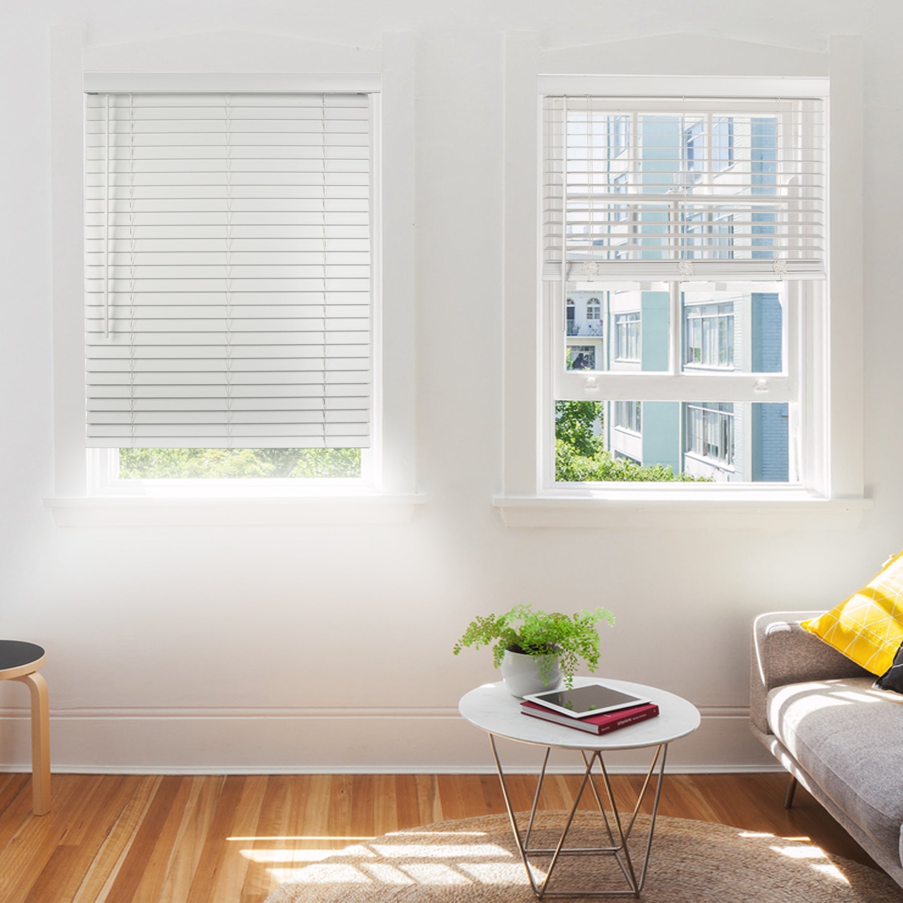 two white faux wood window blinds in a living room