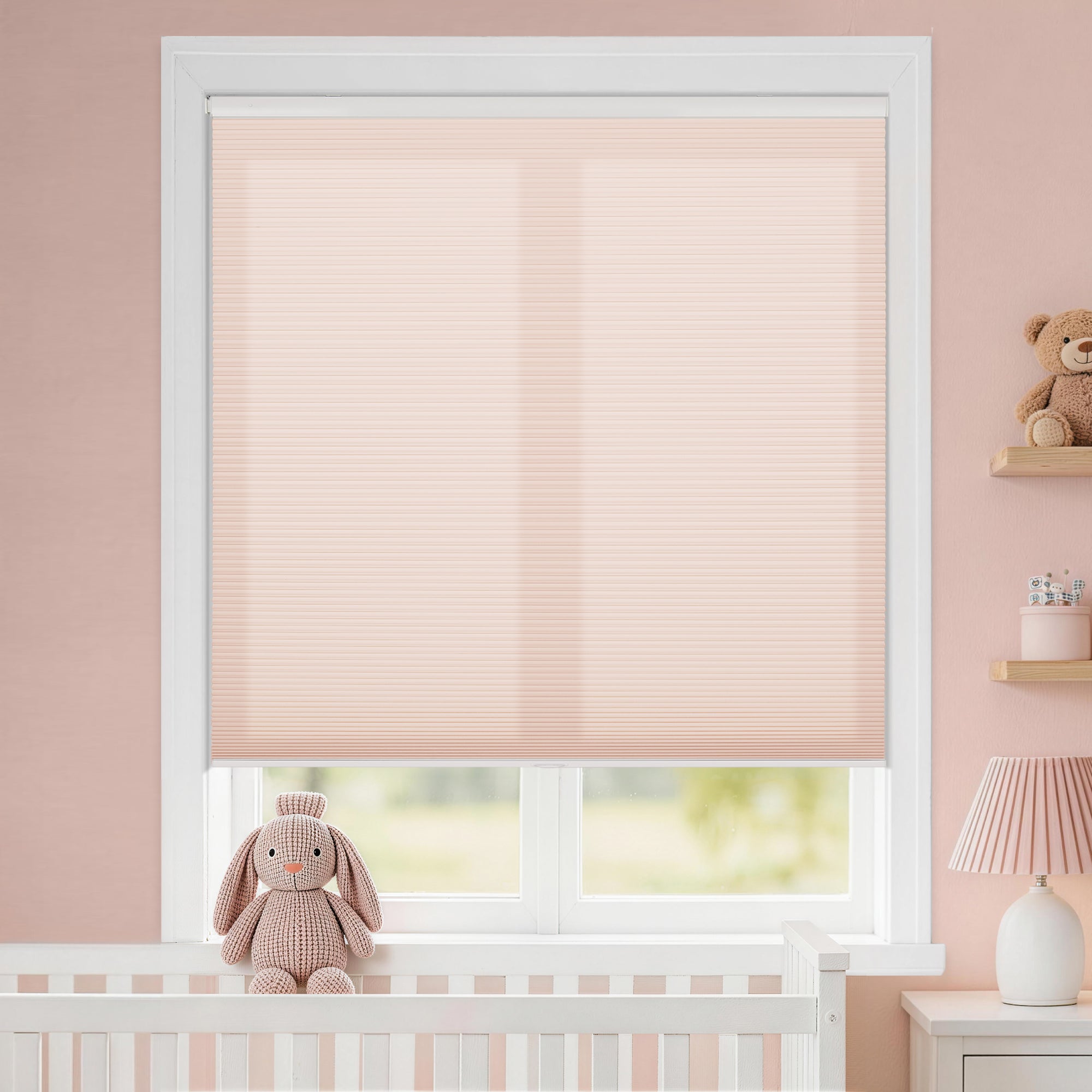 kid's room no drill cordless cellular shades providing a gentle glow that complements the nursery's warm pink walls | hestia blinds