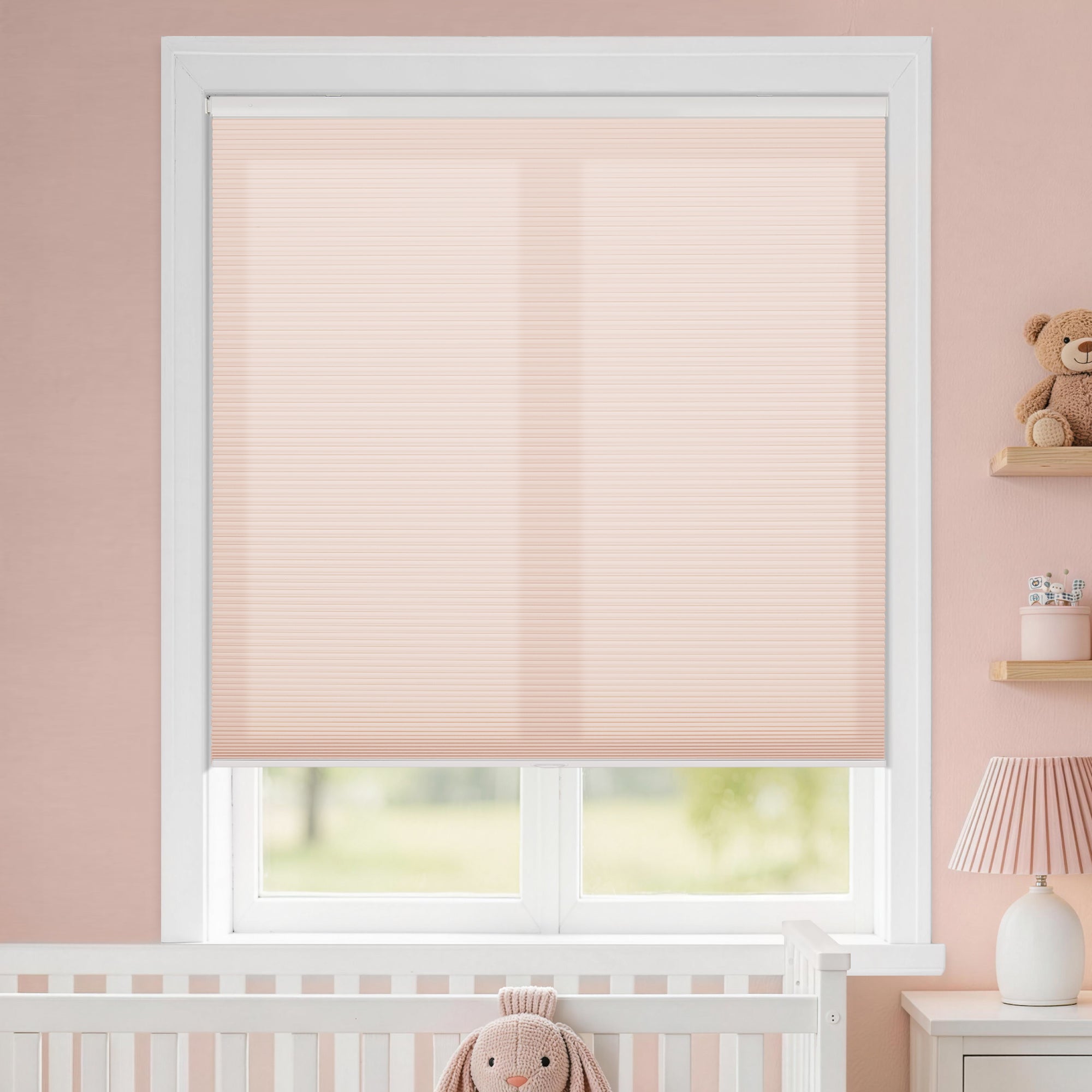kid's room no drill cordless cellular shades providing a gentle glow that complements the nursery's warm pink walls | hestia blinds