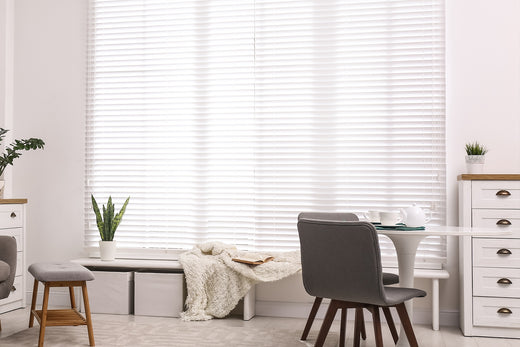 white vinyl blinds for a tall and large living room window