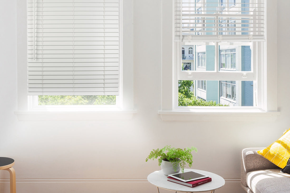 two white faux wood window blinds in a living room