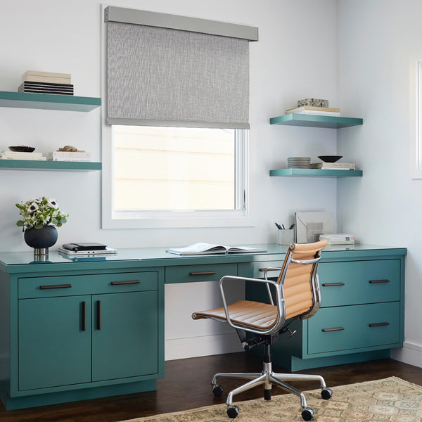 motorized room darkening roller shades in a book room