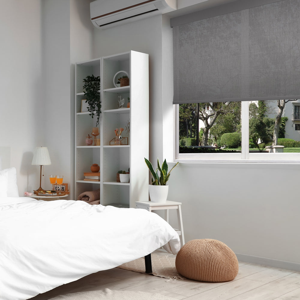 motorized fine-grained semi sheer sunscreen roller shades in a bedroom