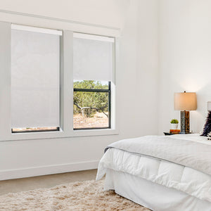 motorized room darkening waterproof roller shades in a bedroom